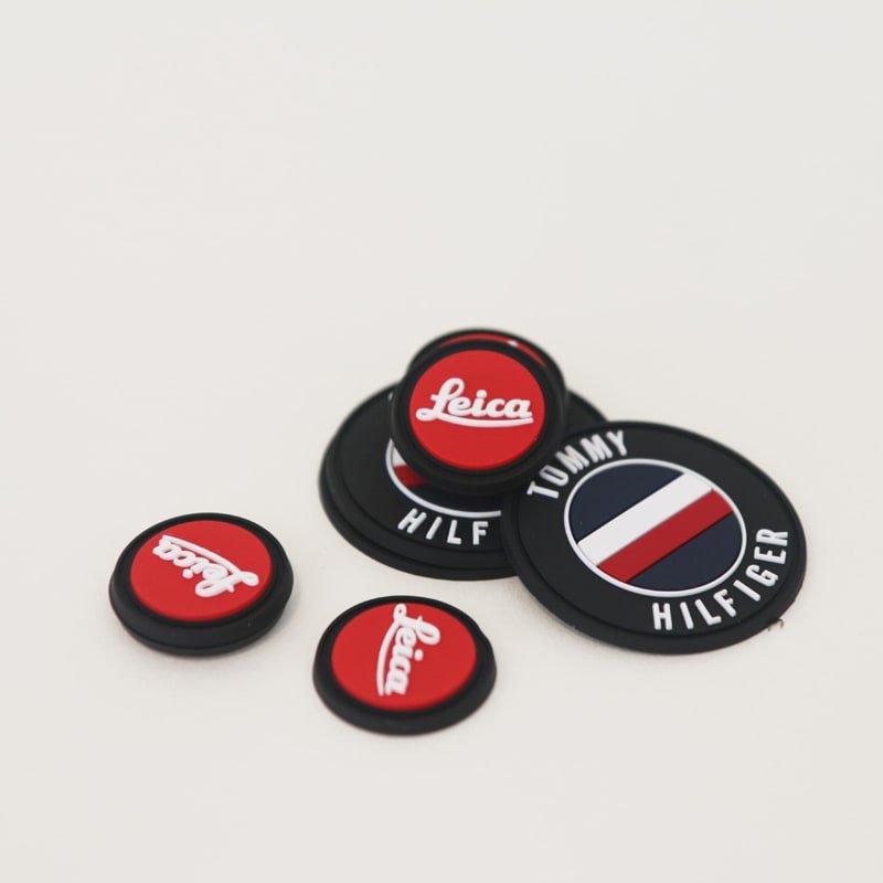 Raised silicone logo label samples with molded relief details